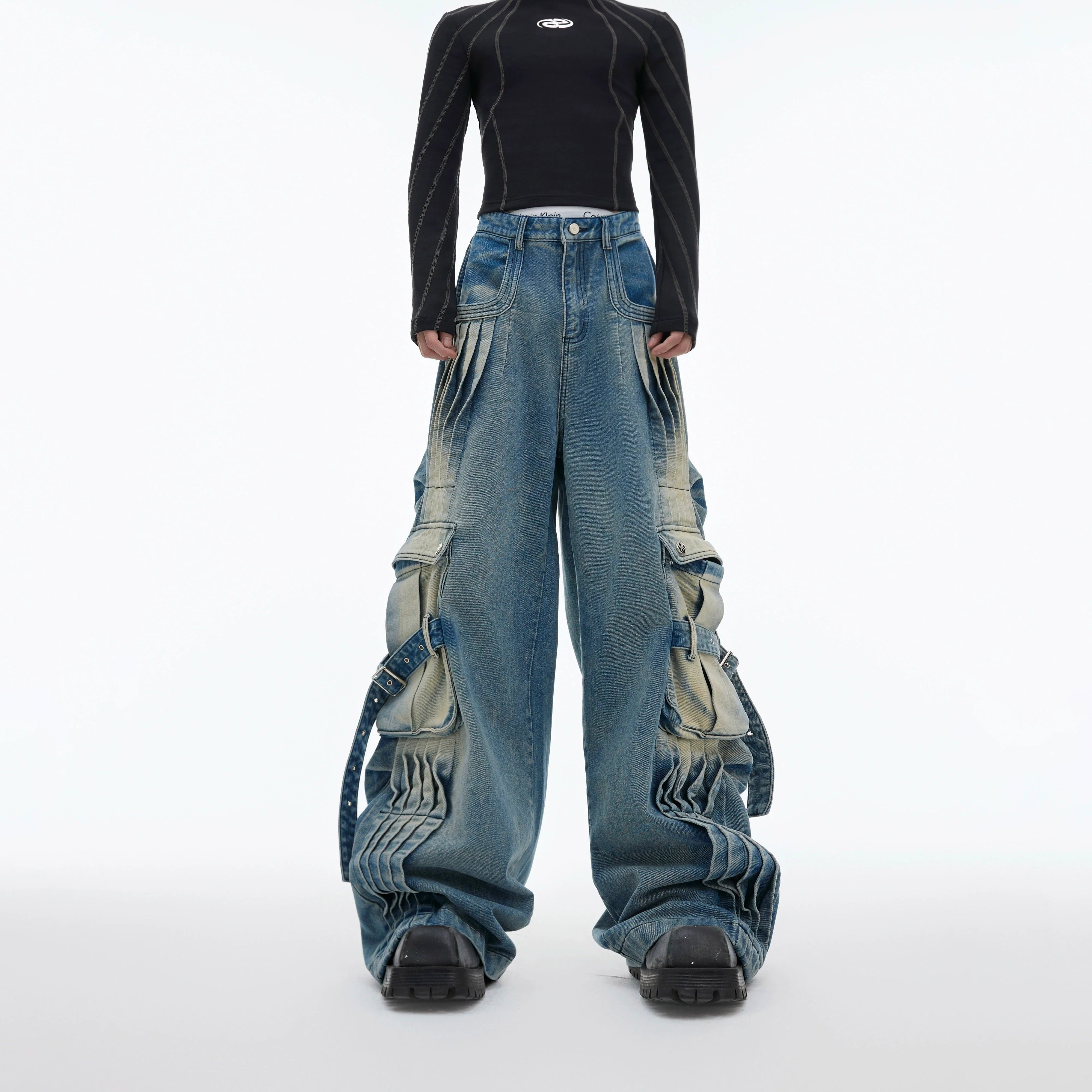 Vintage washed distressed cargo jeans with streetwear aesthetic, featuring utility pockets and punk-rock details