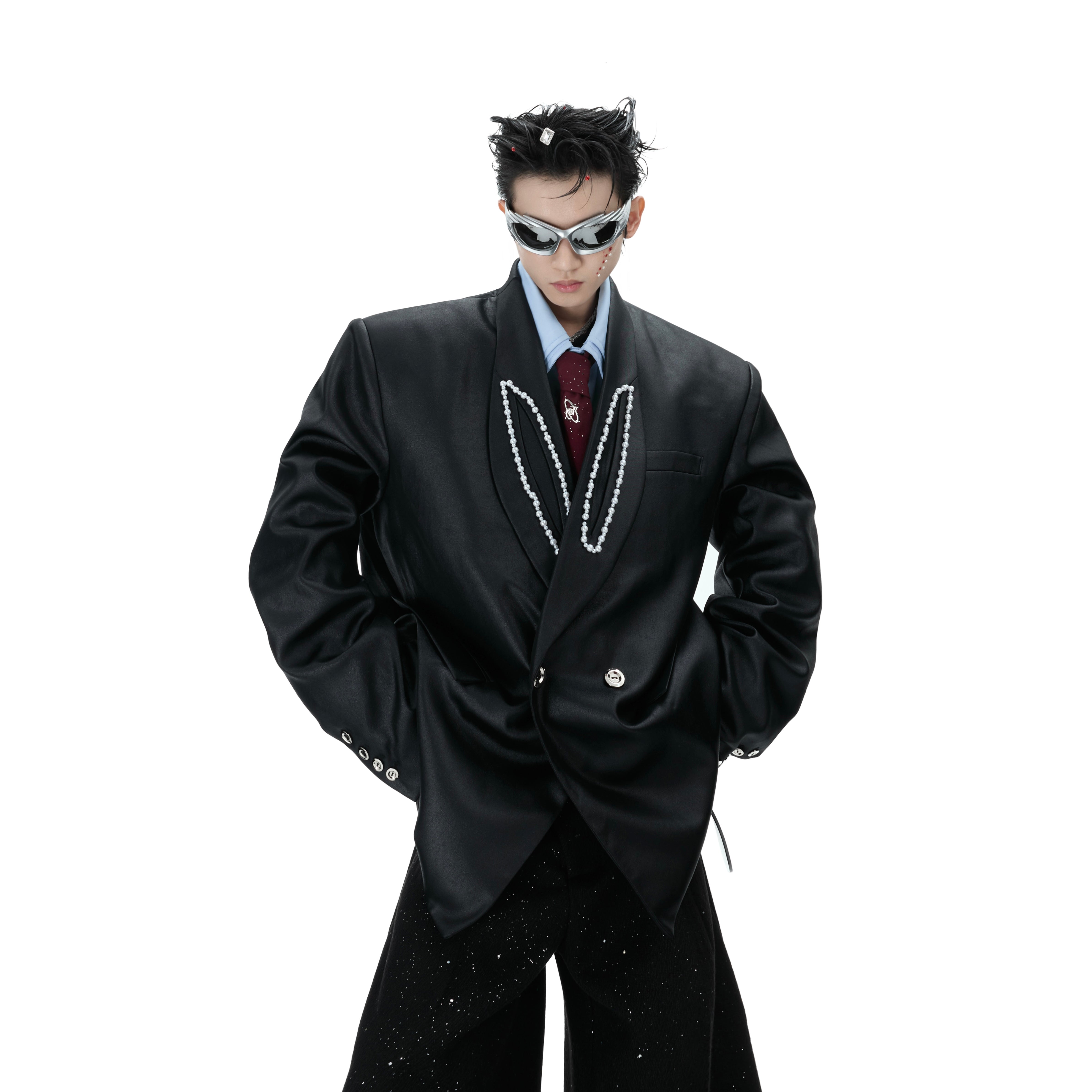 Front view of waxed shoulder-pad blazer with pearl embellishments, showing peak lapel design and structured silhouette