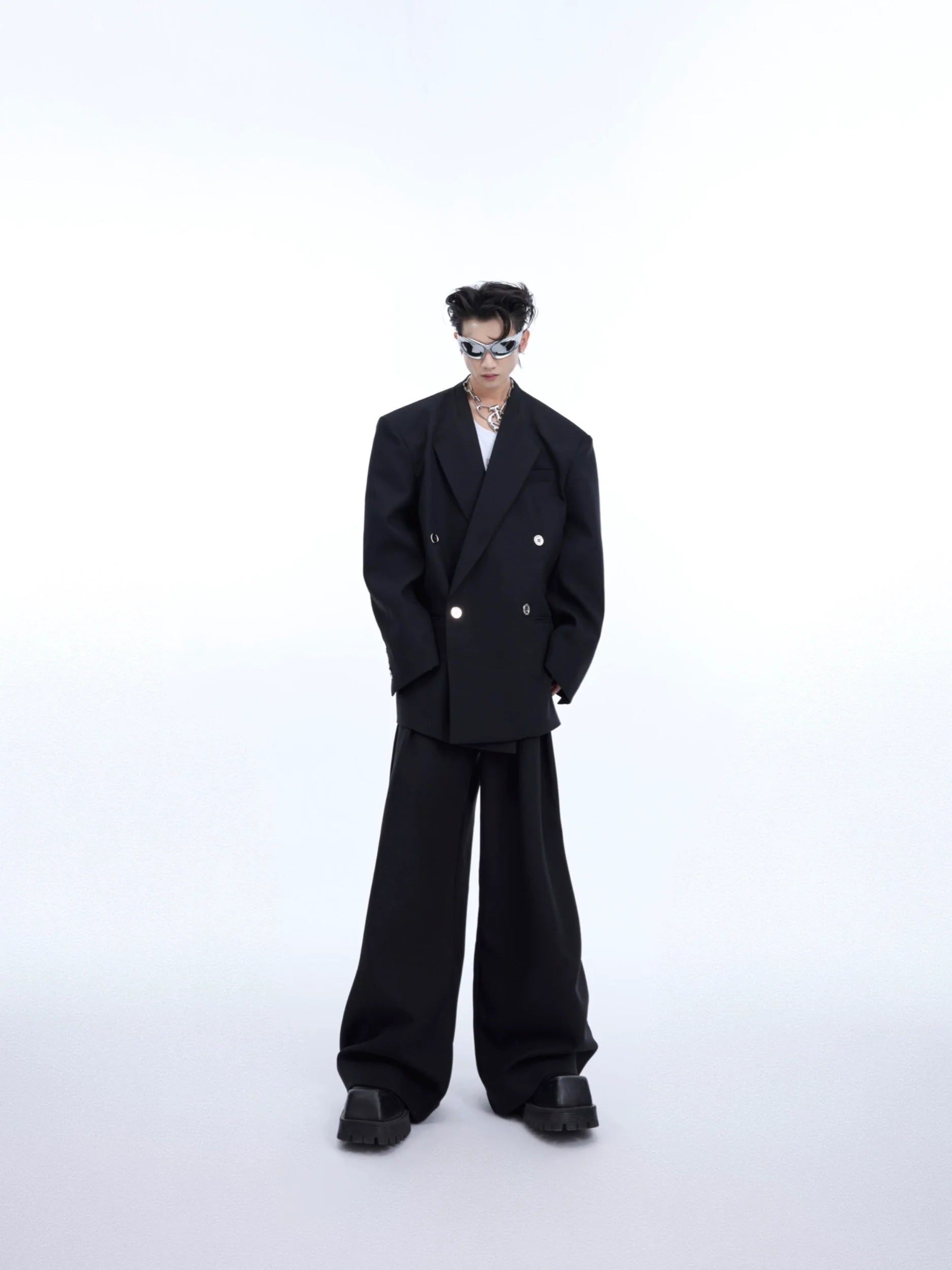 White deconstructed oversized blazer with metal buttons, showcasing avant-garde streetwear style and minimalist design