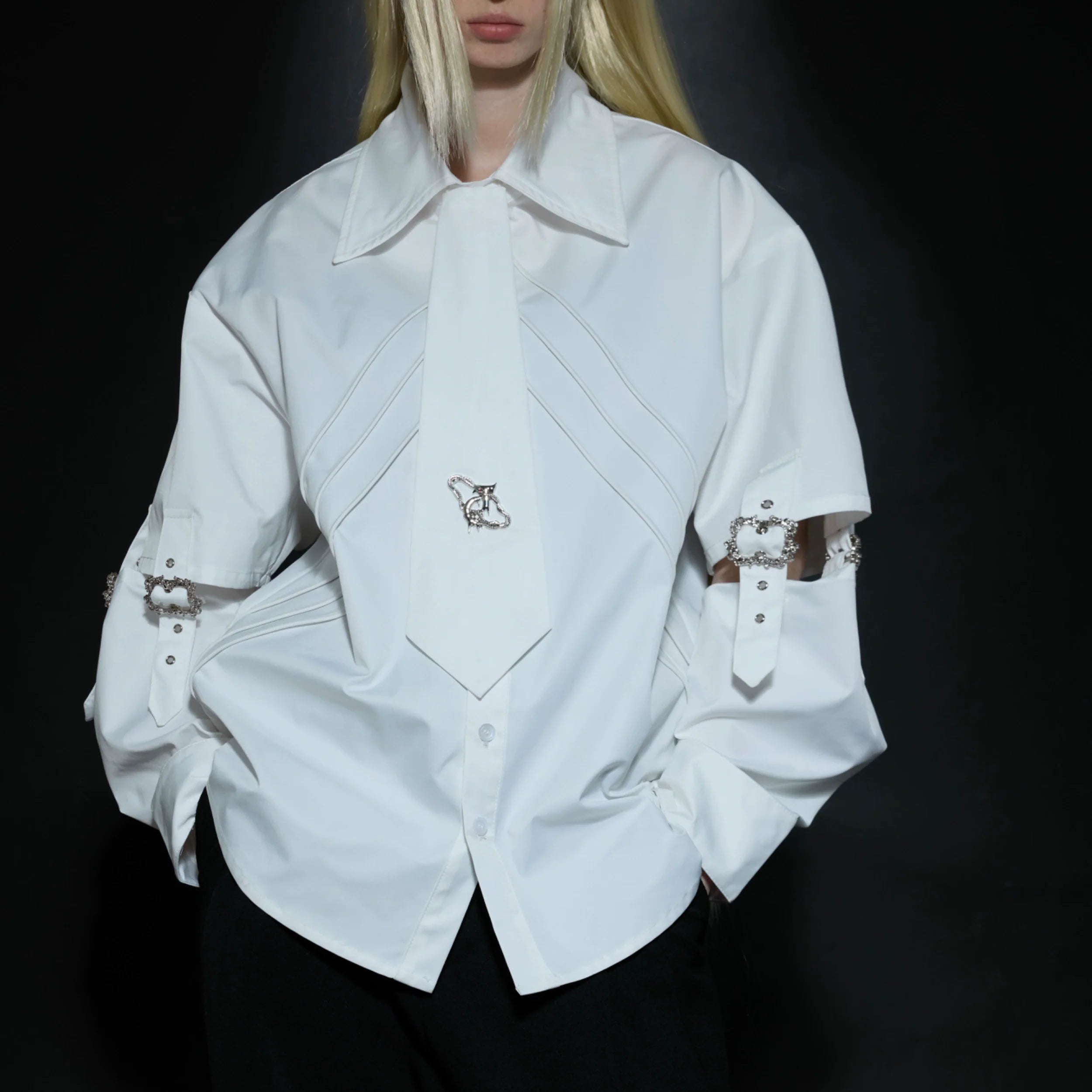 Front view of white deconstructed lace-up shirt with removable panels and punk metal accents