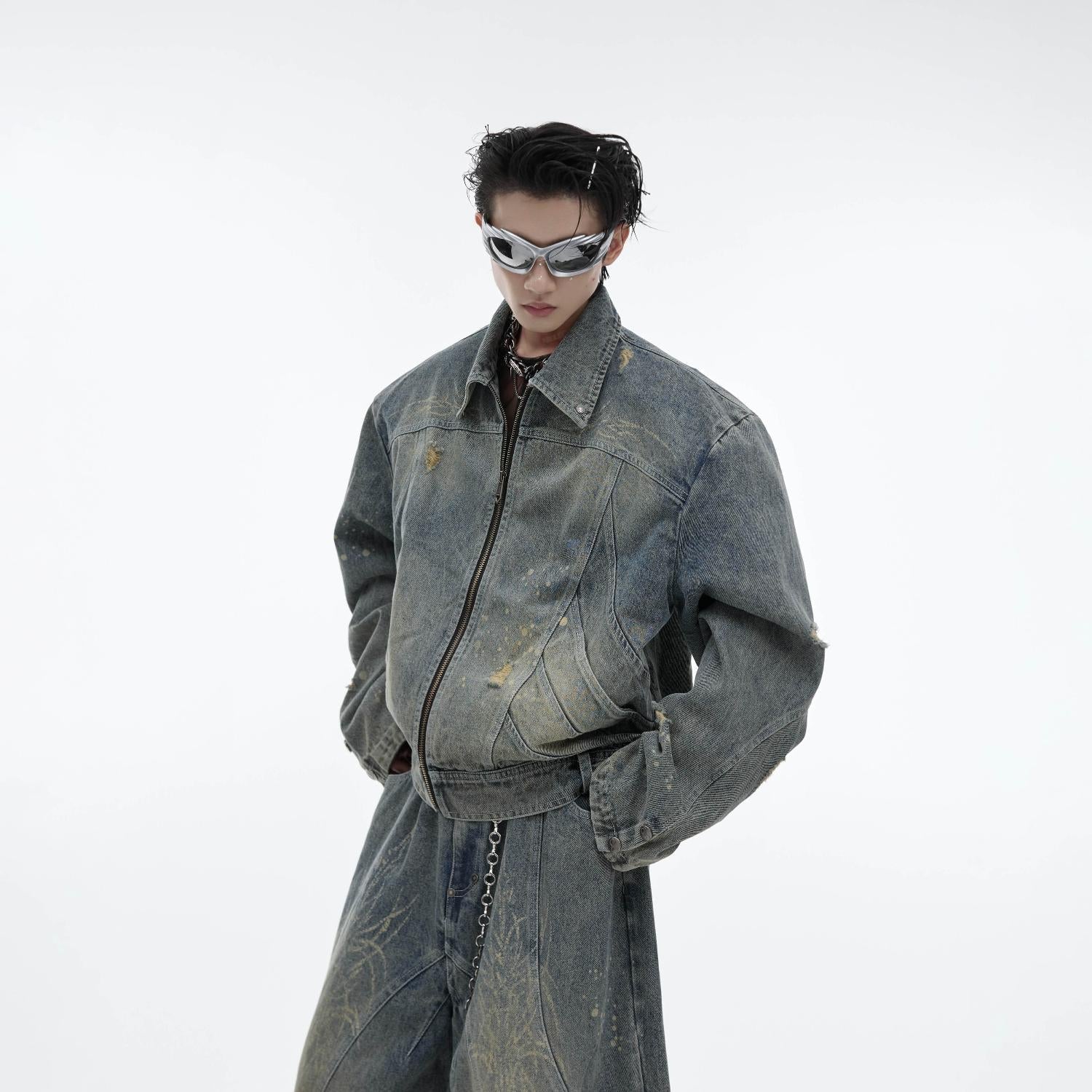 Wide-leg distressed jeans with deconstructed raw hem and vintage wash treatment for edgy streetwear look