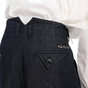 Side profile of relaxed wide-leg denim trousers demonstrating the short-wide silhouette design