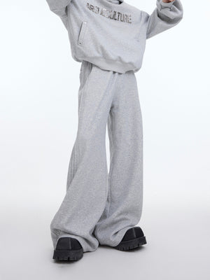 Detail shot of distressed wide-leg pants showing unique seam construction for streetwear look