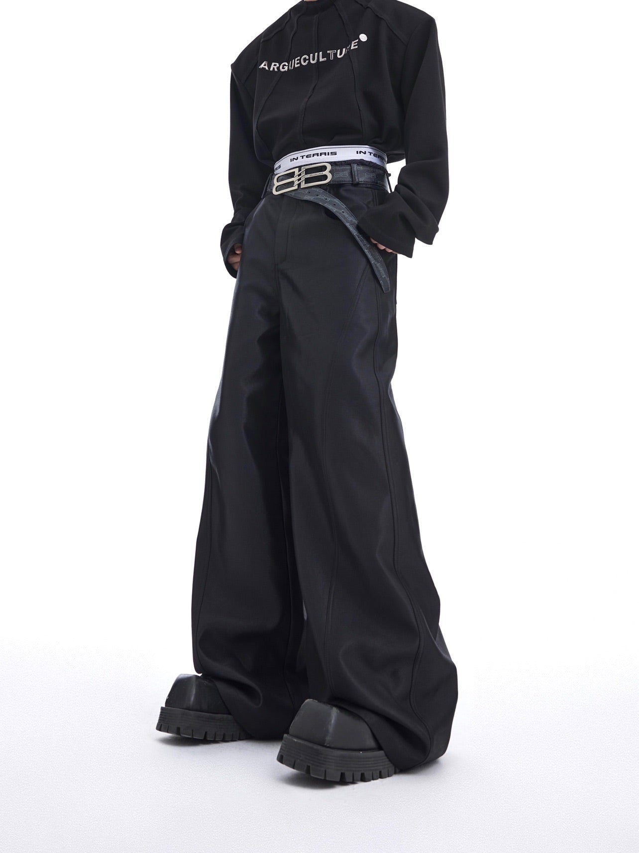 Front view of liquid-shine wide-leg trousers featuring avant-garde metallic patchwork details and loose streetwear fit