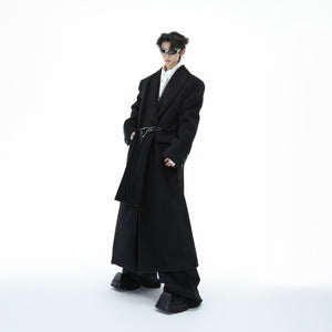 Front view of the long oversized wool coat showing its streetwear-inspired deconstructed design