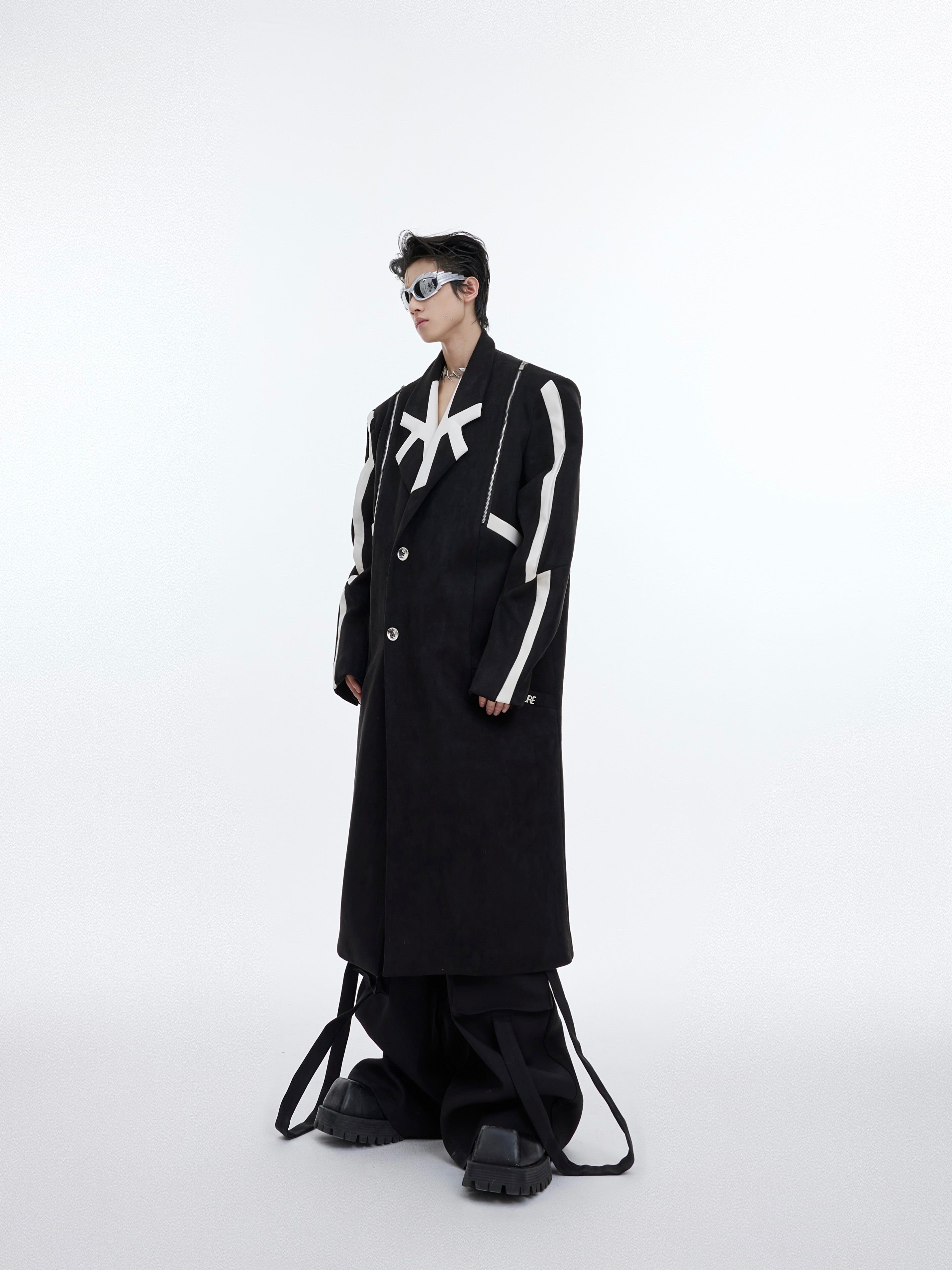 Oversized deconstructed wool trench coat with bold asymmetrical slits, showcasing avant-garde streetwear style