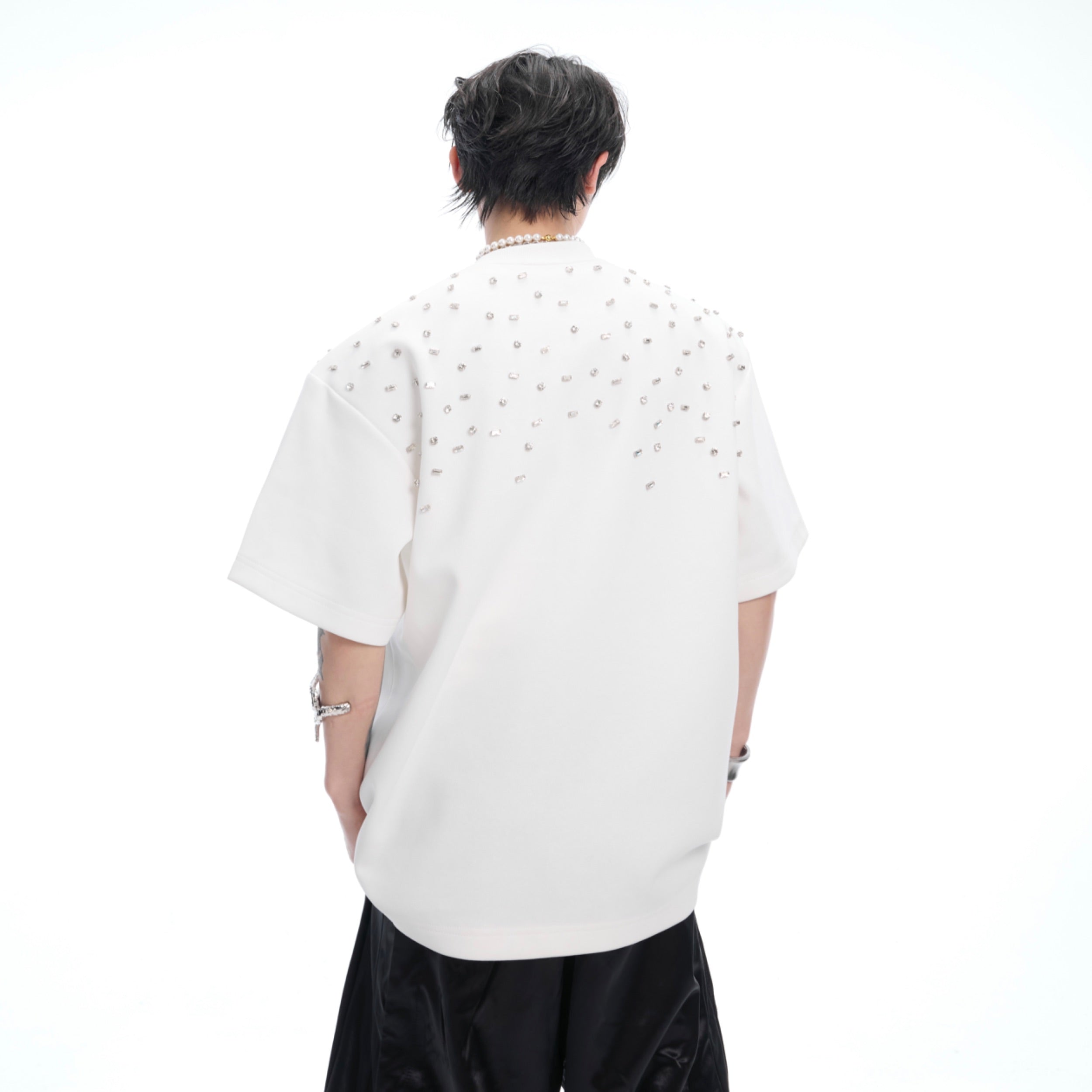 Close-up detail of irregular zirconia crystal embellishments on premium cotton crewneck tee