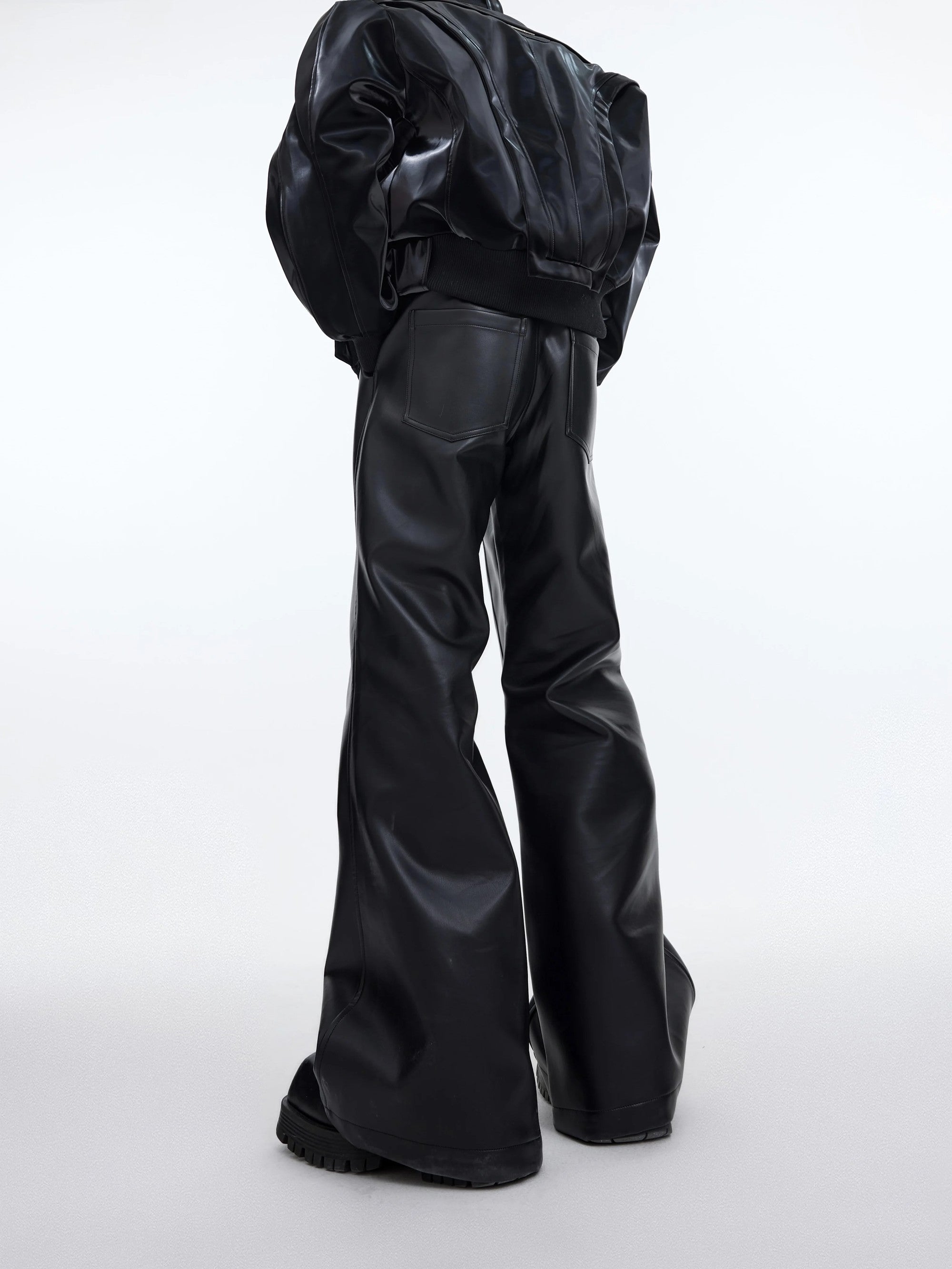 Close-up of 3D deconstructed stitching on matte PU leather pants