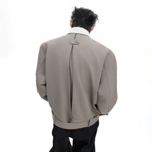 Close up of vintage pointed collar and asymmetric button design