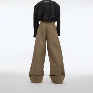 Close-up of high-quality hardware and rivet details on suit pants.