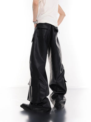 Model wearing baggy metal studded leather cargo pants in street setting