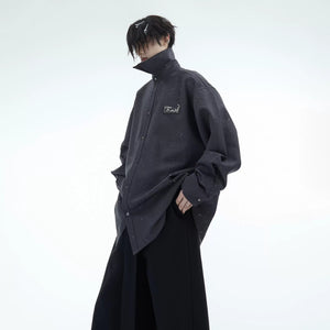 Close-up of red shimmer fabric and metallic flame embroidery