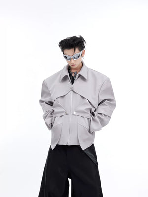 Close-up of the deconstructed patchwork and zipper detail on a metallic jacket