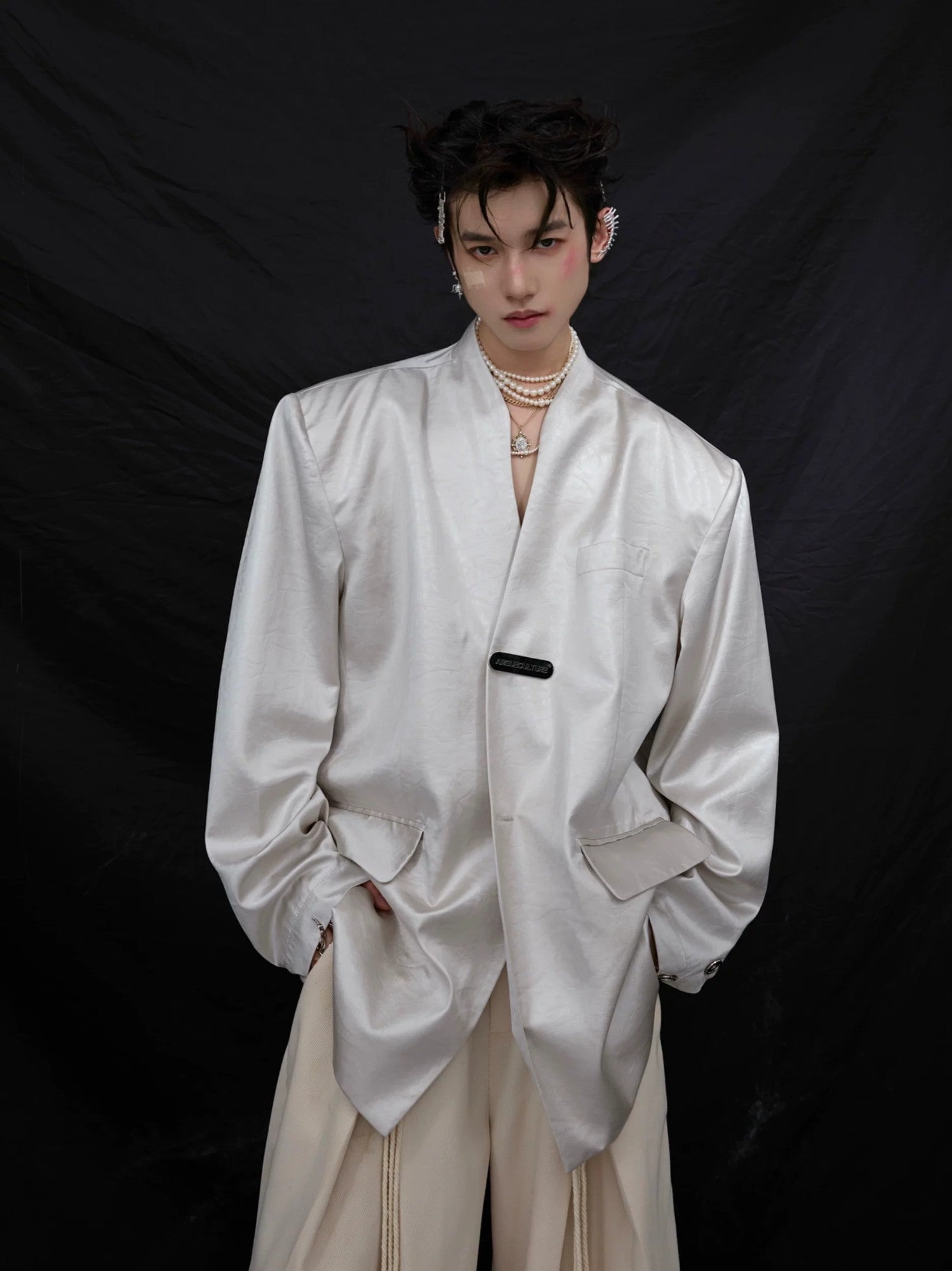 Front view of silver liquid metal texture collarless oversized blazer