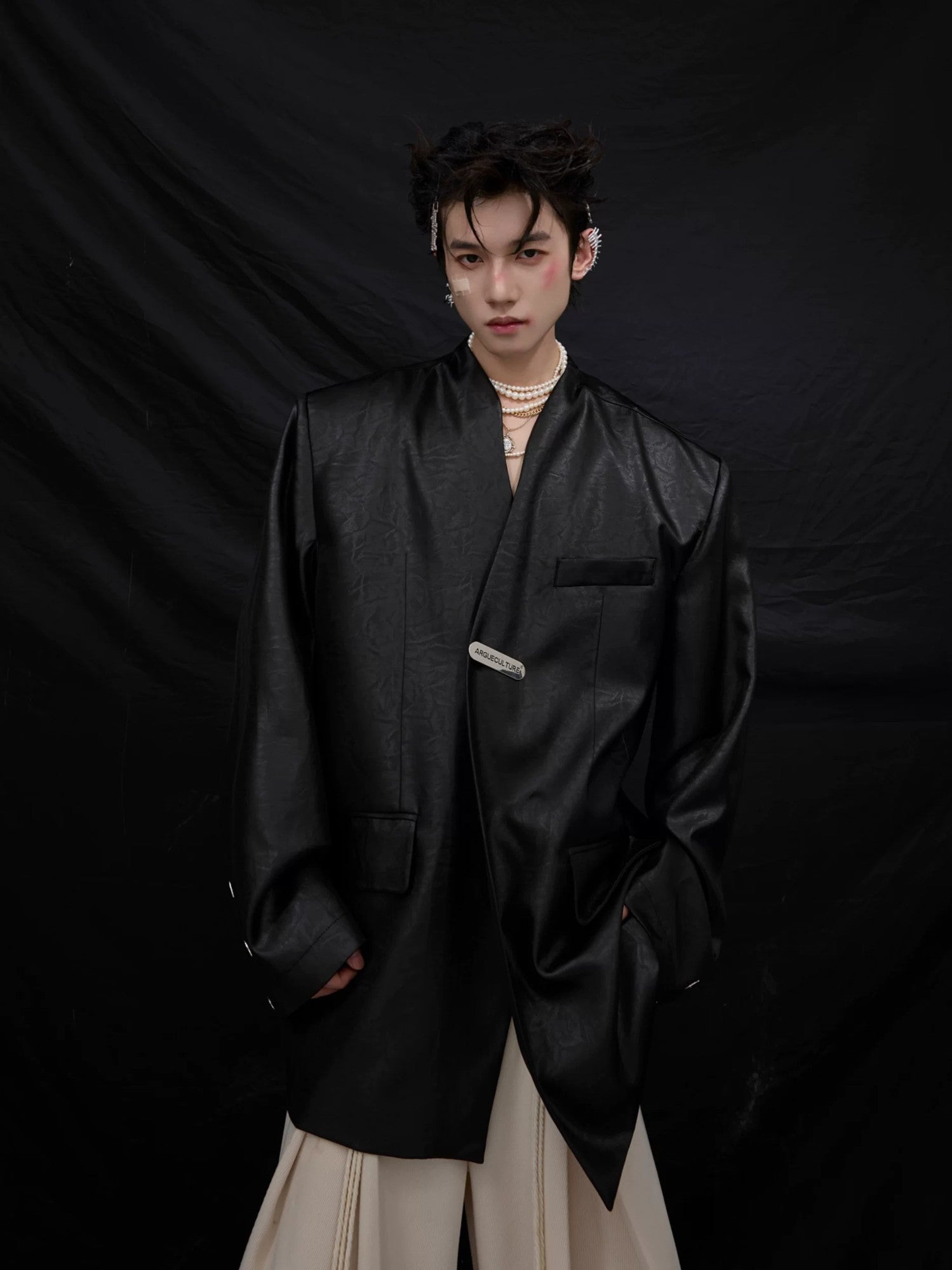 Close-up detail of the metallic liquid texture on the blazer fabric