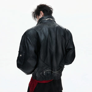 Close-up of metal zipper details and distressed oil-waxed leather texture