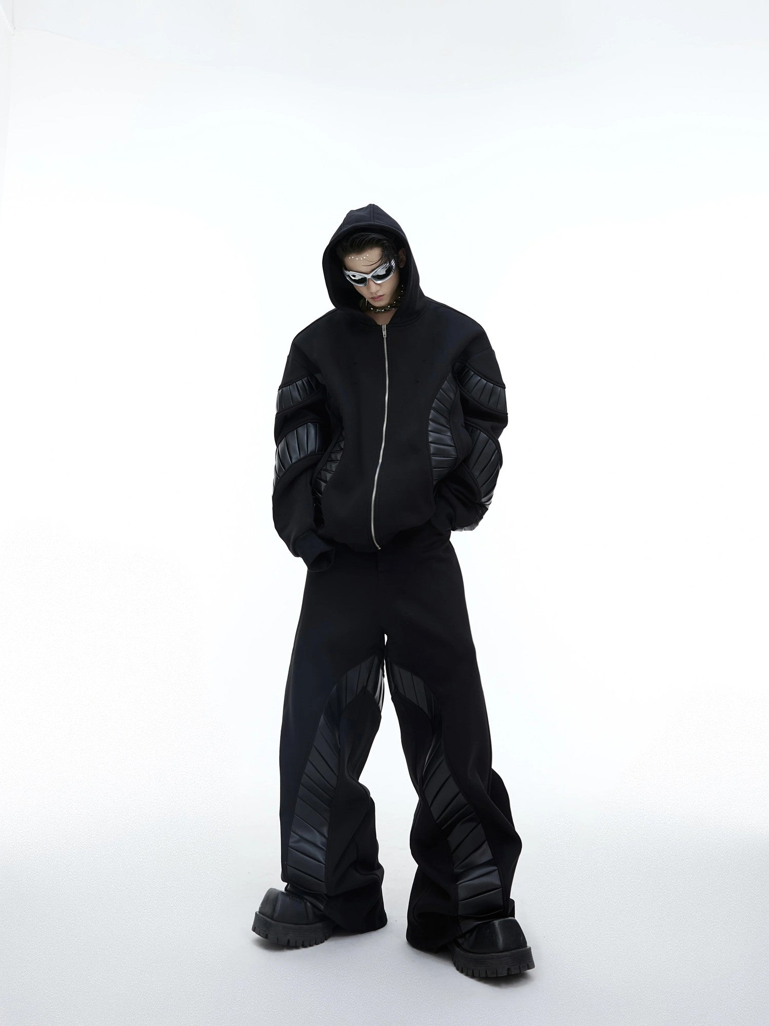Front view of black deconstructed PU leather patchwork oversized tracksuit