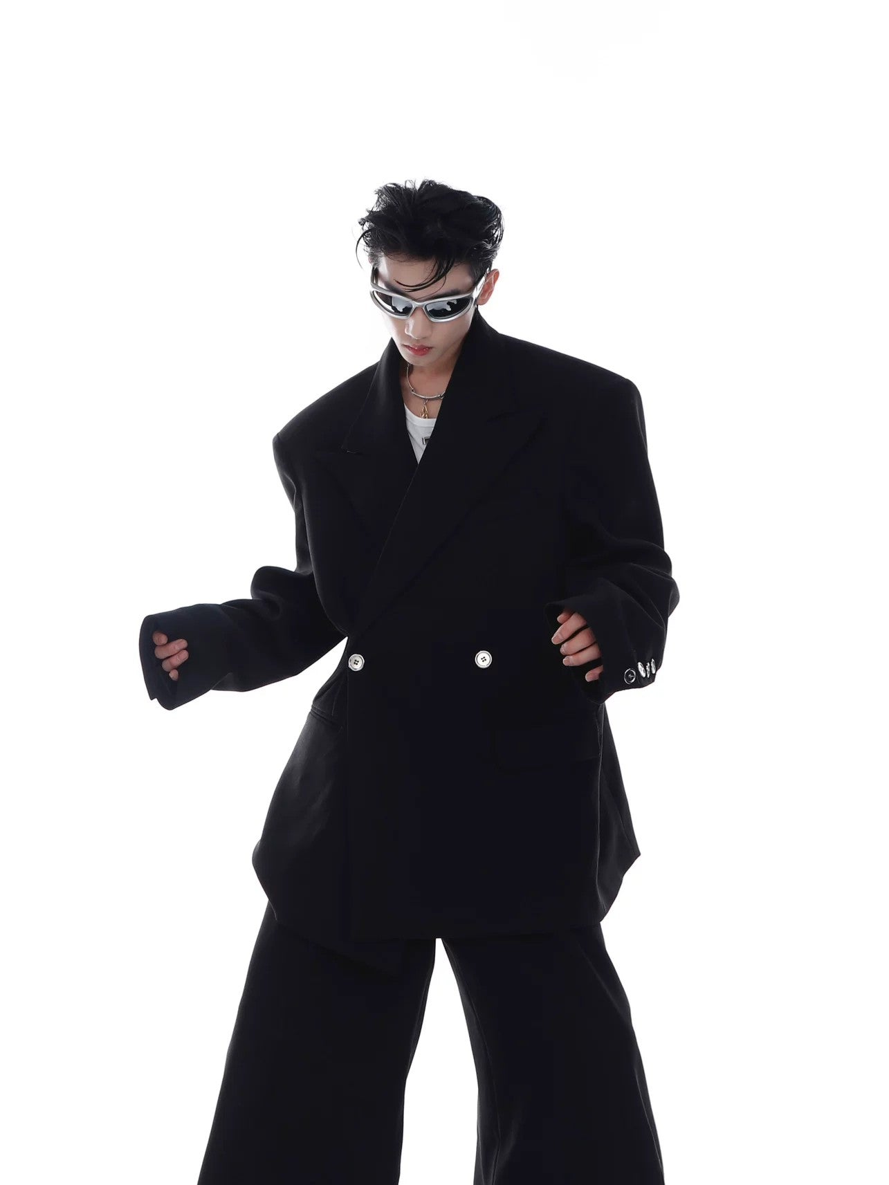 Side profile of a gray drape blazer showing the relaxed fit