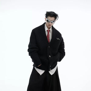 Streetwear model wearing an oversized green knit cardigan in an urban setting.