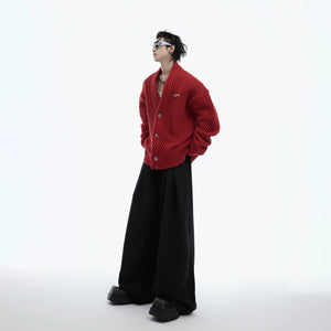 Flatlay of the black ribbed cardigan paired with baggy jeans and sneakers.