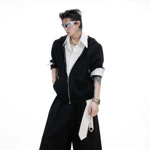 Detail of the baggy pleated pants with layered waist design