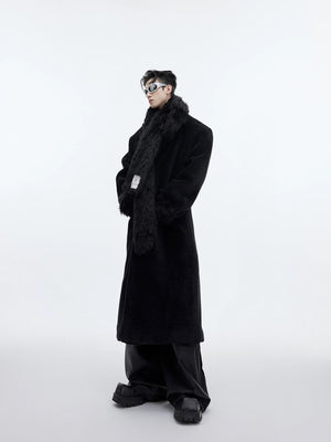 Man wearing black oversized wool coat with built-in scarf design