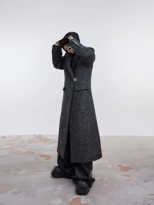 Model wearing a dark gray oversized wool coat with shoulder pads