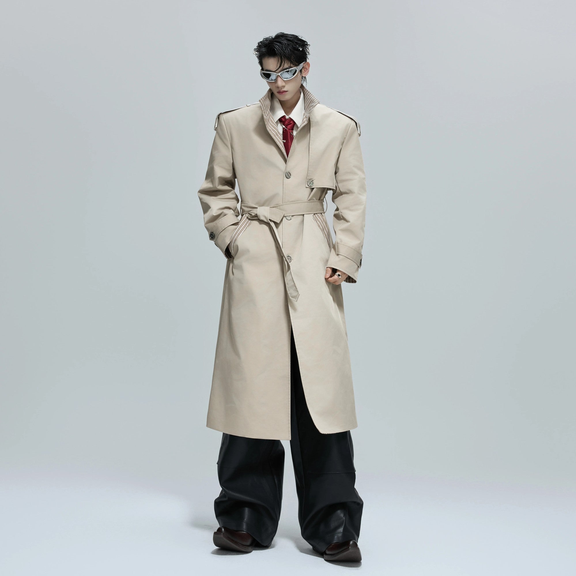 Side view of a khaki long trench coat with stand collar and loose fit