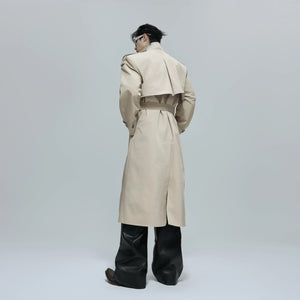 Model wearing the oversized patchwork trench coat in an urban street setting