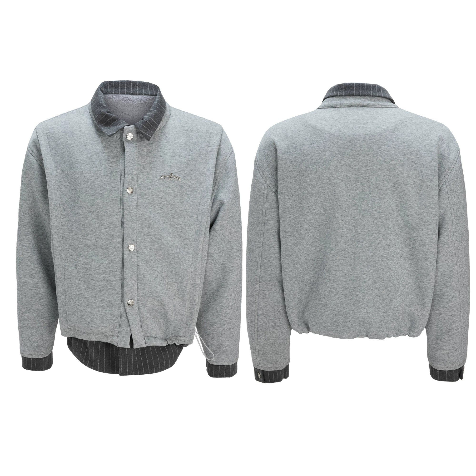 Male model wearing a black striped streetwear jacket in a casual setting.