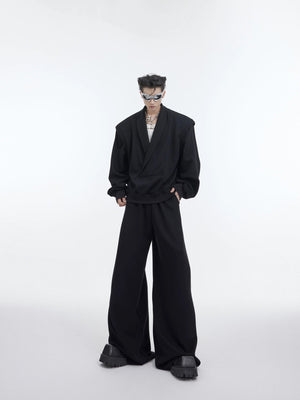 Model wearing black oversized V-neck sweatshirt with metal accents streetwear