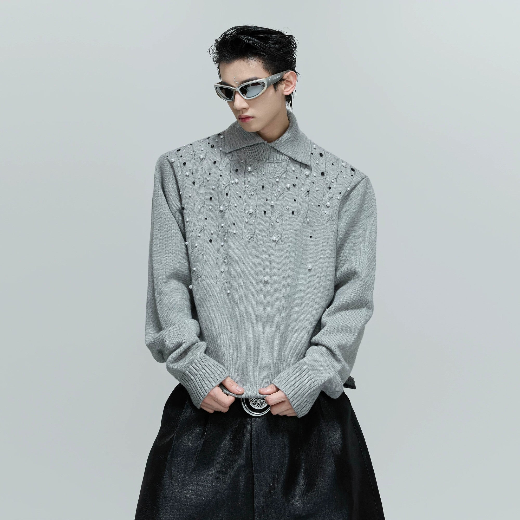 Front view of black heavyweight pearl embellished cable knit sweater