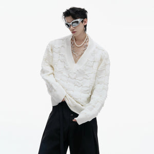 White oversized cotton sweater with distressed V-neck and pearl décor.