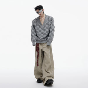 Apricot colored soft knit sweater with pearl highlights for street style.