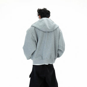 Close-up of the pearl trim and premium fabric on the hooded sweatshirt
