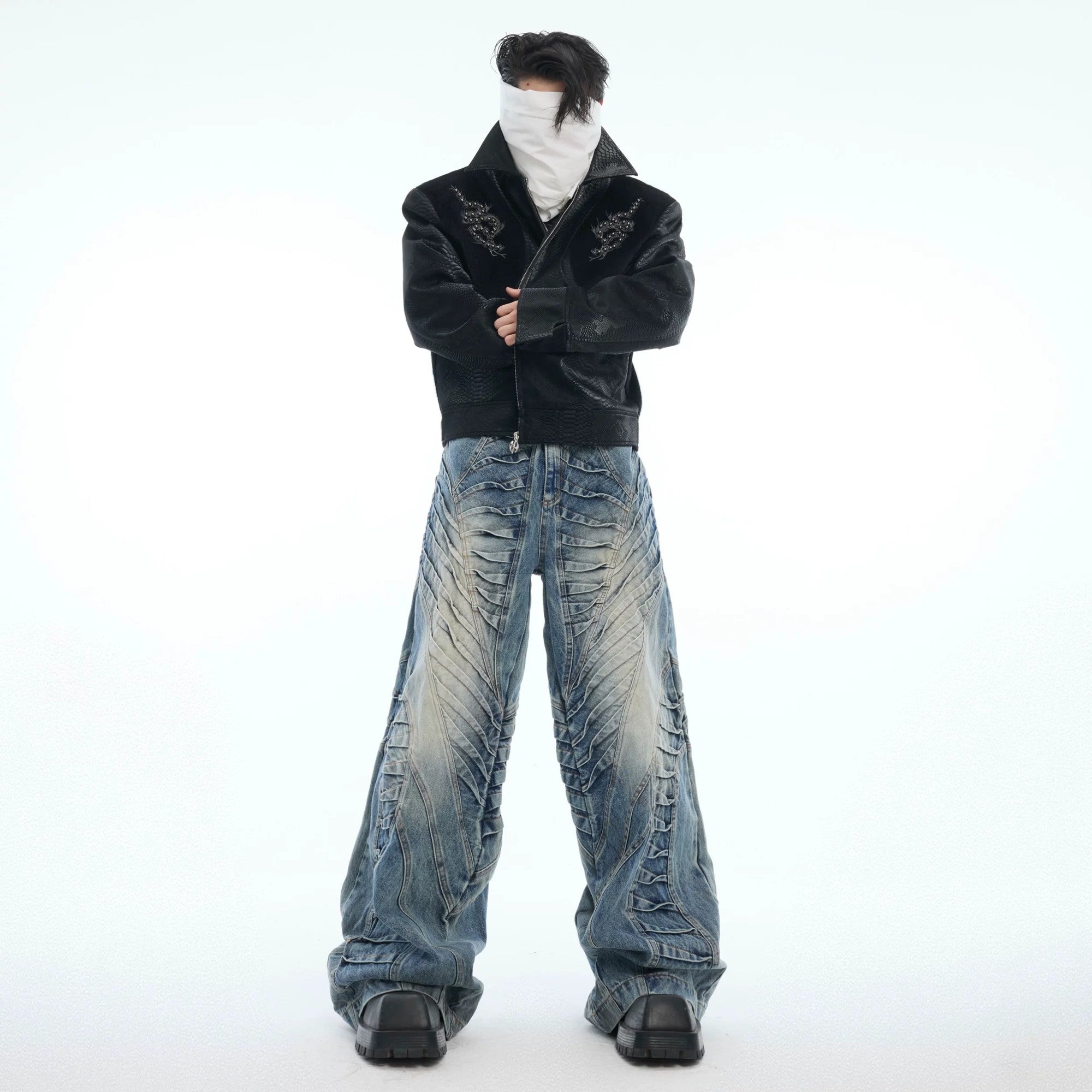 Close-up of side pleat and distressed detailing on blue jeans