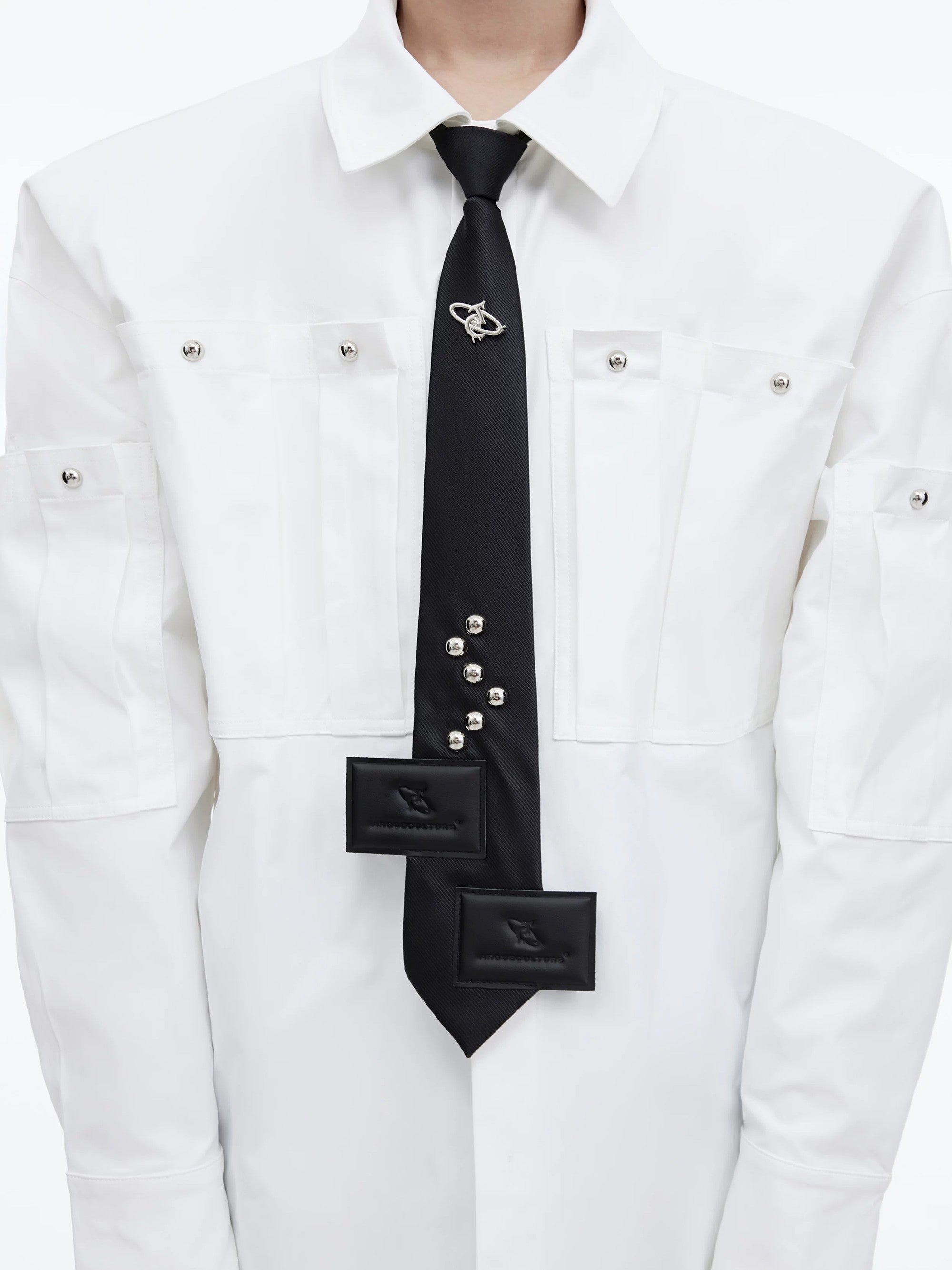Front view of black pre-tied streetwear tie with metal logo detail
