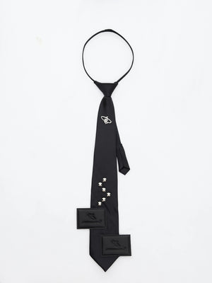 Flatlay of the black arrow-shaped necktie on a white background