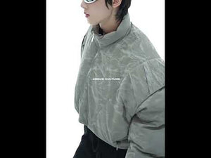 360-degree video showcasing deconstructed cropped puffer jacket with glossy texture and pleated details