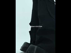 Video demonstration of the deconstructed wide-leg trousers in motion showing their unique pleat design