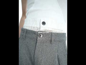 Video showing how these drop-crotch trousers move and flow with unique pleated detailing in motion