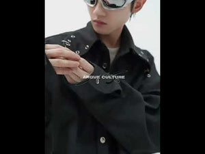 Video showcasing the unique features of deconstructed white shirt with metal details and shoulder pads