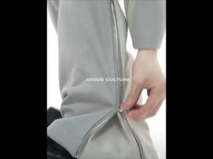 Video demonstration showing movement and fit of deconstructed shoulder-pad jacket suit with leather trim details