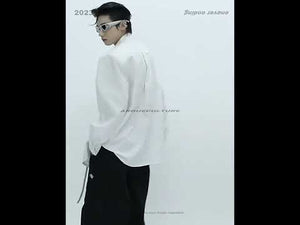 Video demonstration showing how to style this white deconstructed pleated shirt with split neckline