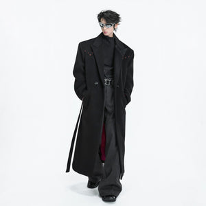 Street style shot of a model wearing the long double-breasted black coat