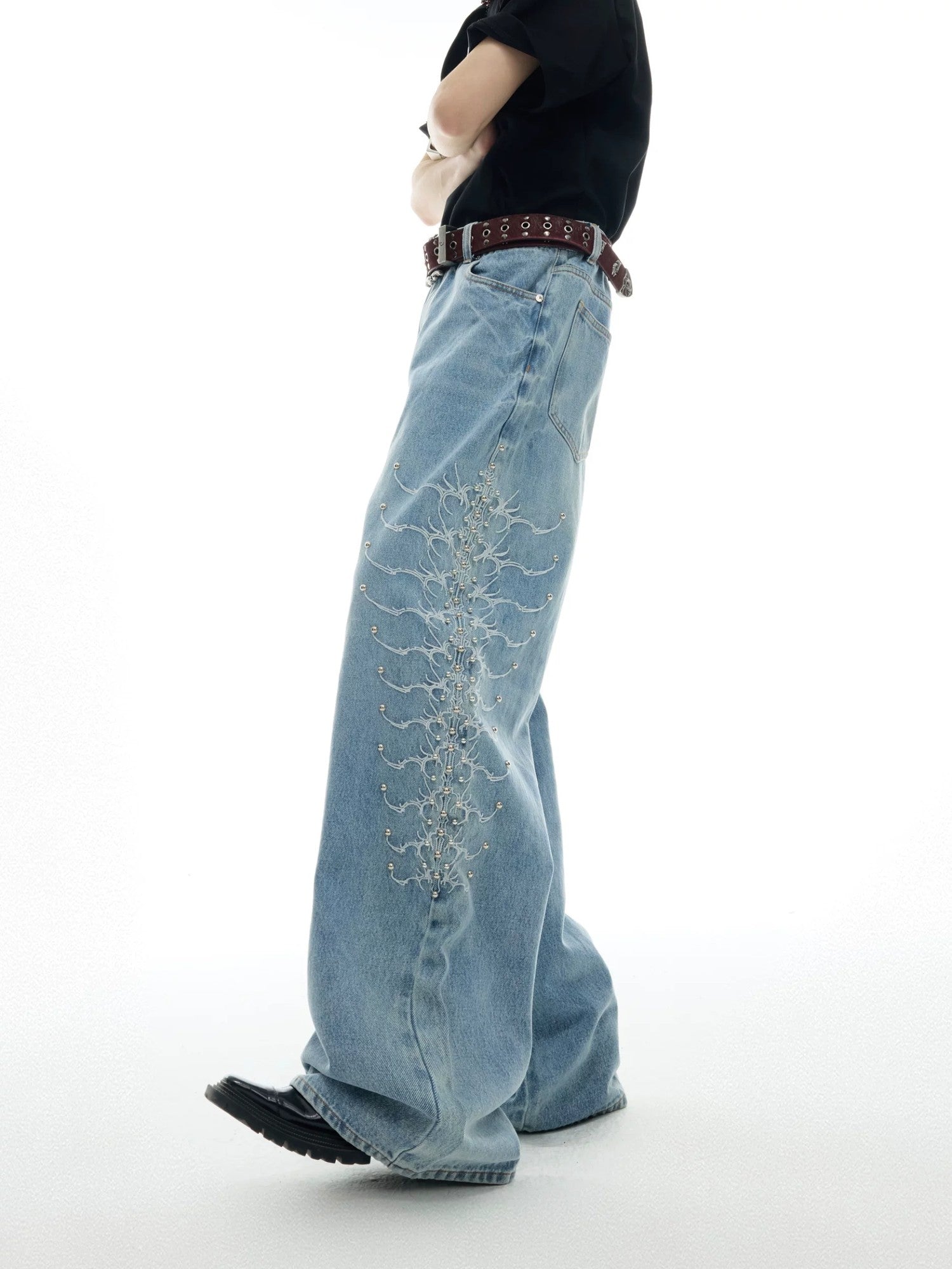 Front view of retro spine metal studded washed baggy denim jeans