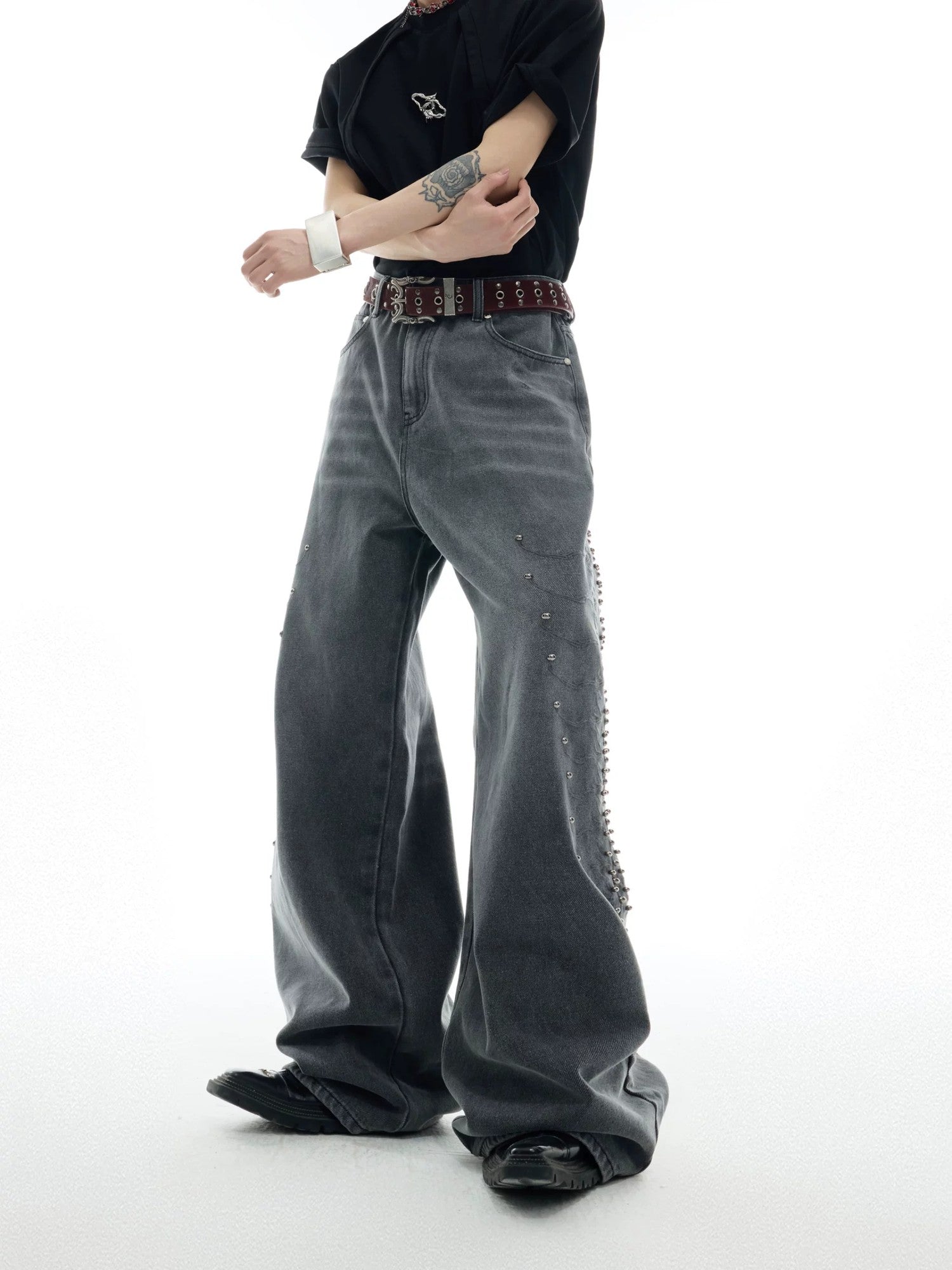 Close up of spine metal studs and snake eye embroidery on jeans