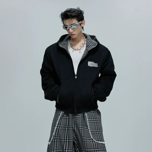 Showcasing the reversible design of the grey houndstooth sweatshirt