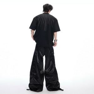 Oversized rhinestone t-shirt paired with baggy denim for a street look