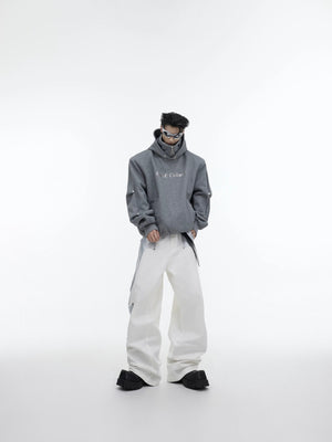 Model wearing white deconstructed hoodie with distressed jeans